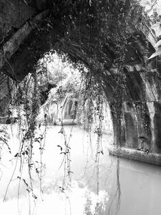 Picture of small, old limestone bridge spanning a waterway. Picture taken in China.