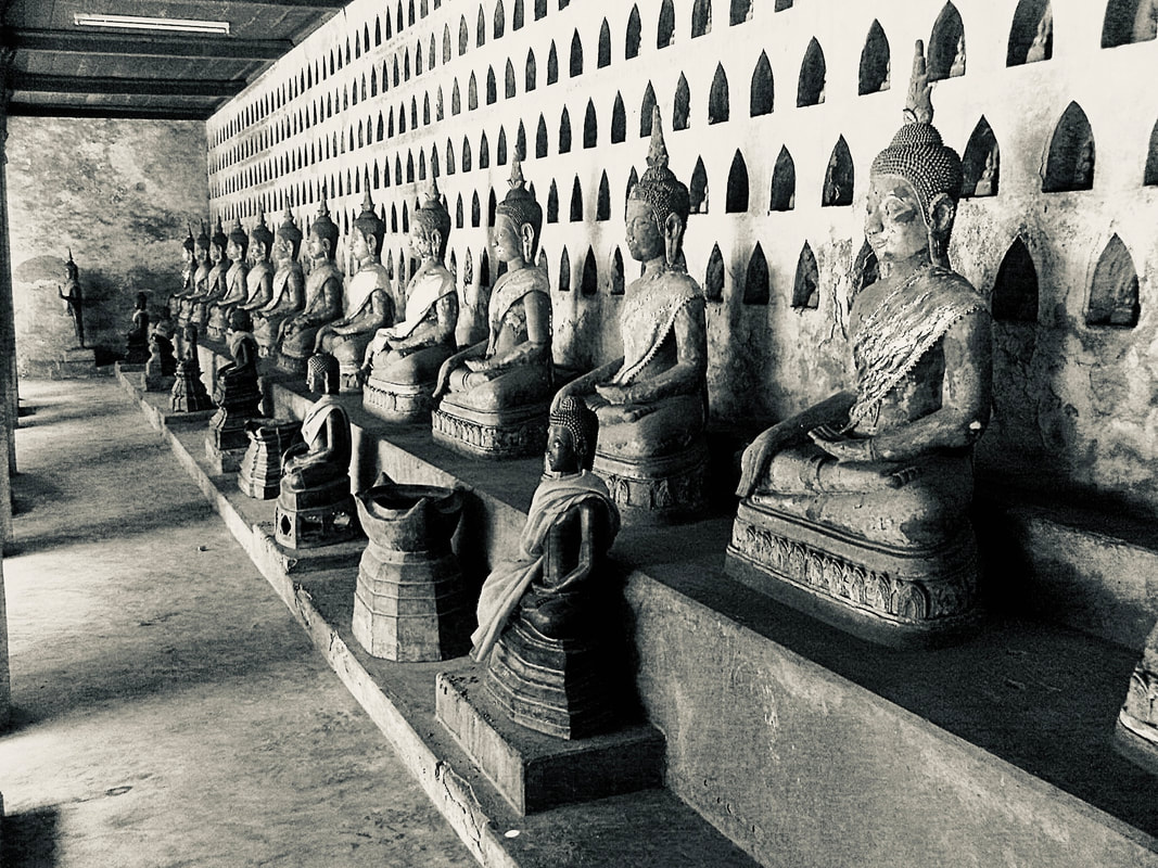 Picture of series of Buddha statues lined up in a row. Picture taken in China.